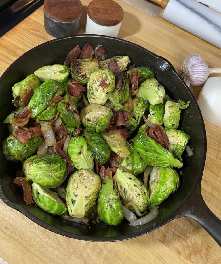 savory brussels sprouts in cast iron pan with bacon, onions, and garlic