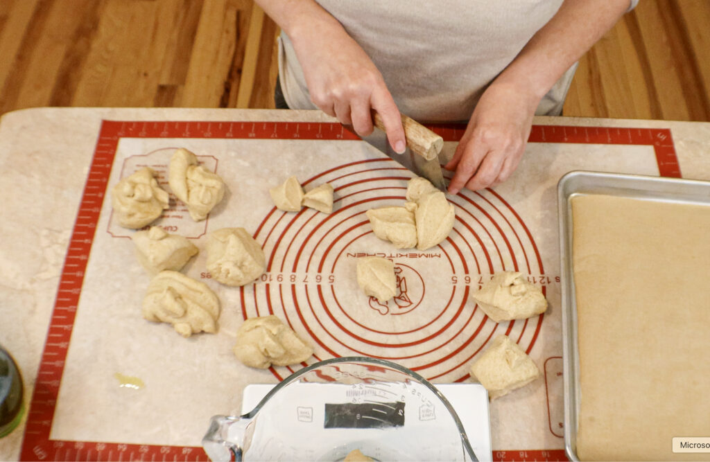 Dividing dough for garlic knots made with fresh milled flour.