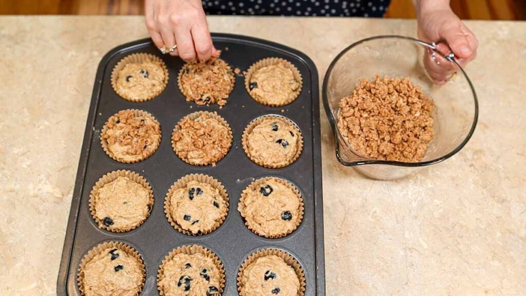 Fresh milled flour blueberry muffin batter topped with streusel before baking